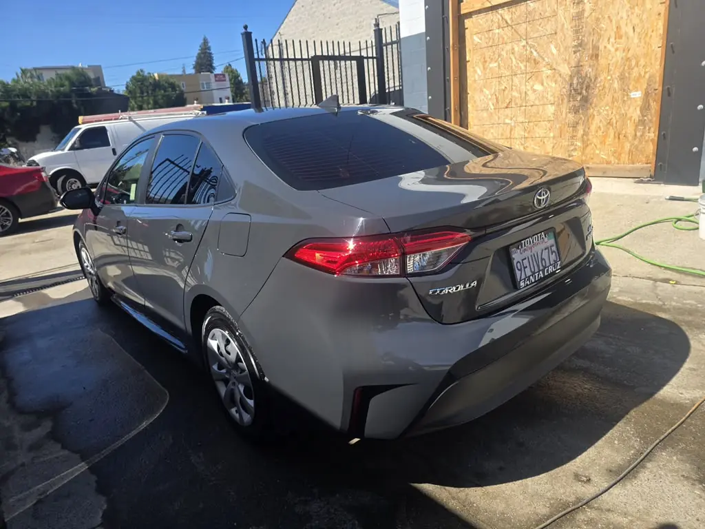 Gray Toyota Corolla after repair, parked outside the shop