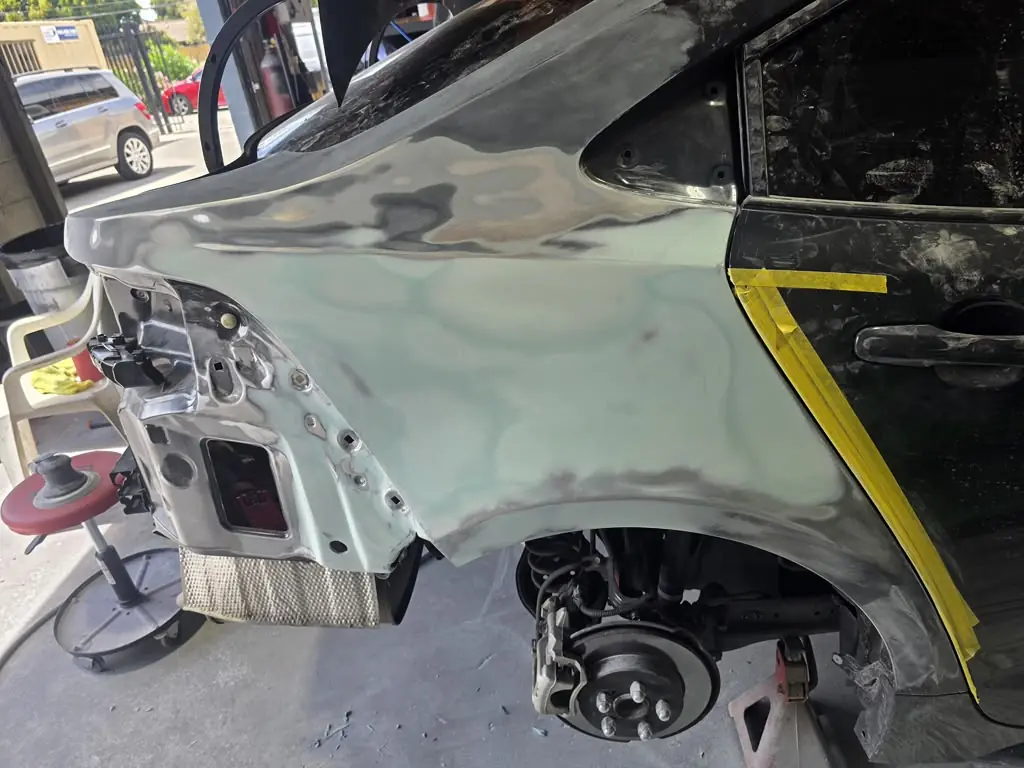 Quarter panel sanded to bare metal during repair
